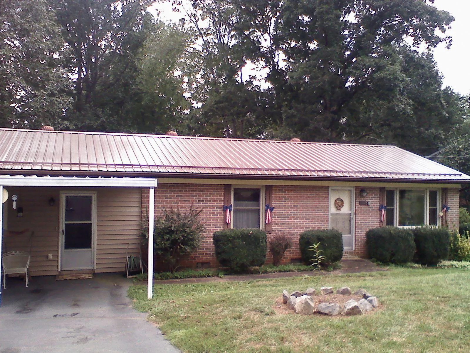 Bronze metal roof and carport on a brick ranch home — Roof Repair work by our crew in Avoca