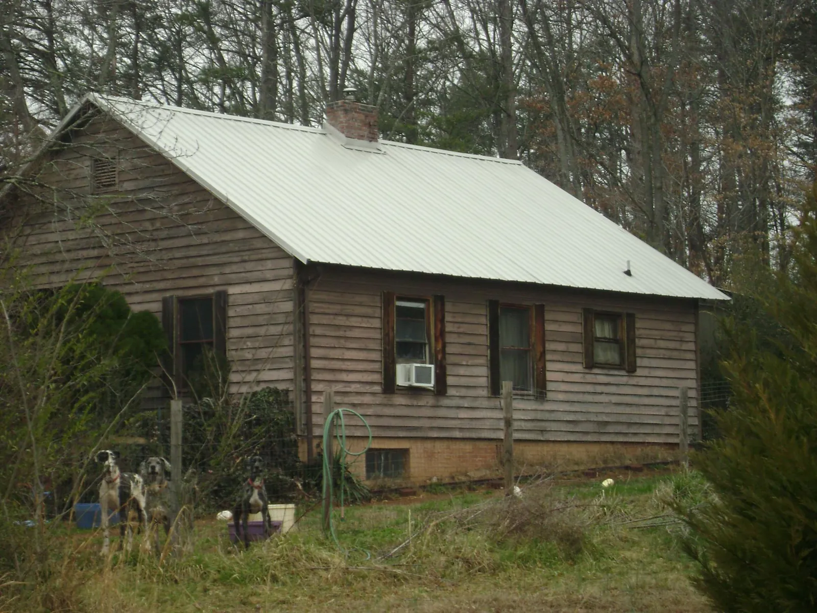 White metal roof on an old wood sided farmhouse, from a Metal Roof Installation job in Avoca