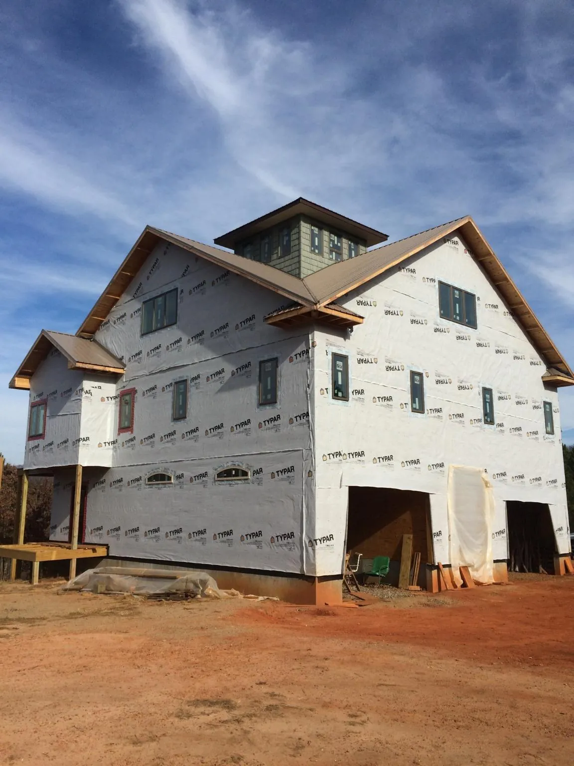 New two story house under construction with a cupola and gabled roofs in Avoca